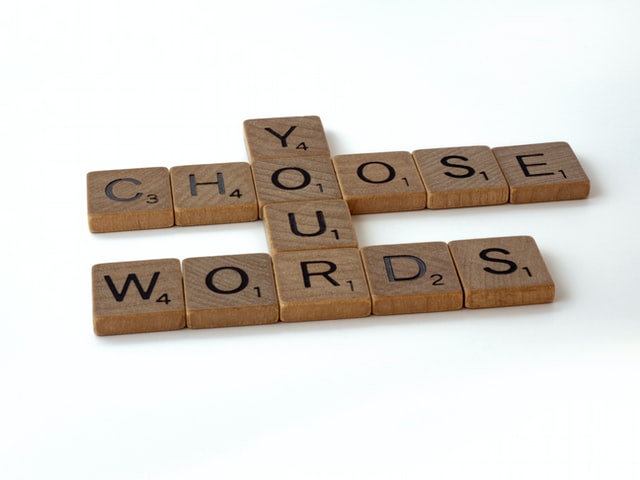 This picture is Scrabble tiles set up to say "Choose Your Words"