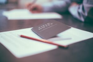 This is a picture of a white piece of paper on a wooden surface. On top of it is a wooden pencil and a black notebook that says “Field Notes” on the front. When you want to leave your labels behind, one step is to take inventory. 