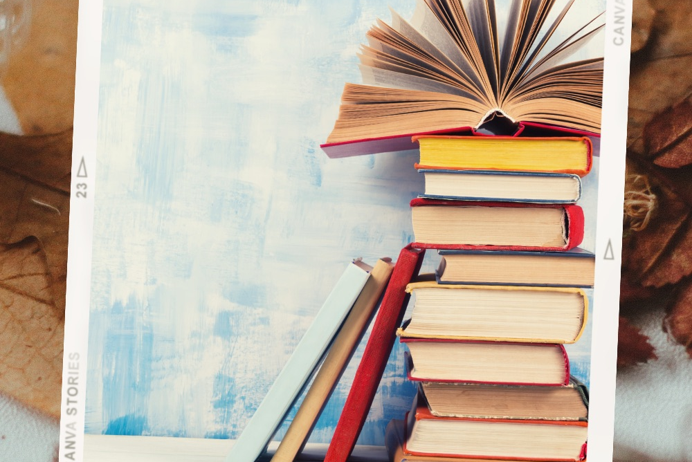 stack of books with a background of fall leaves, feature image for Fall Book Reviews