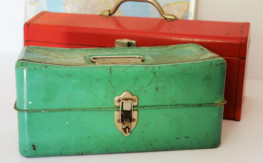 This is a picture of two toolboxes. The one in front is light green, and the one in back is red. They are both old and dirty. I chose this picture because we are creating a mental health toolbox.