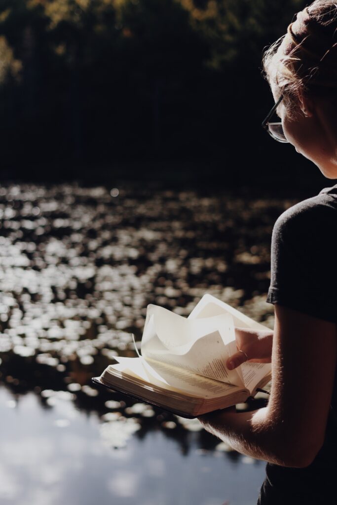 This is a picture of a girl by a lake reading a book or the Bible. This represents a way I continue building my strong foundation.