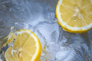 This is a picture of two lemon halves in water. The lemons are in the top right and bottom left corners. They represent lemon soda, which we had while on vacation in Italy.