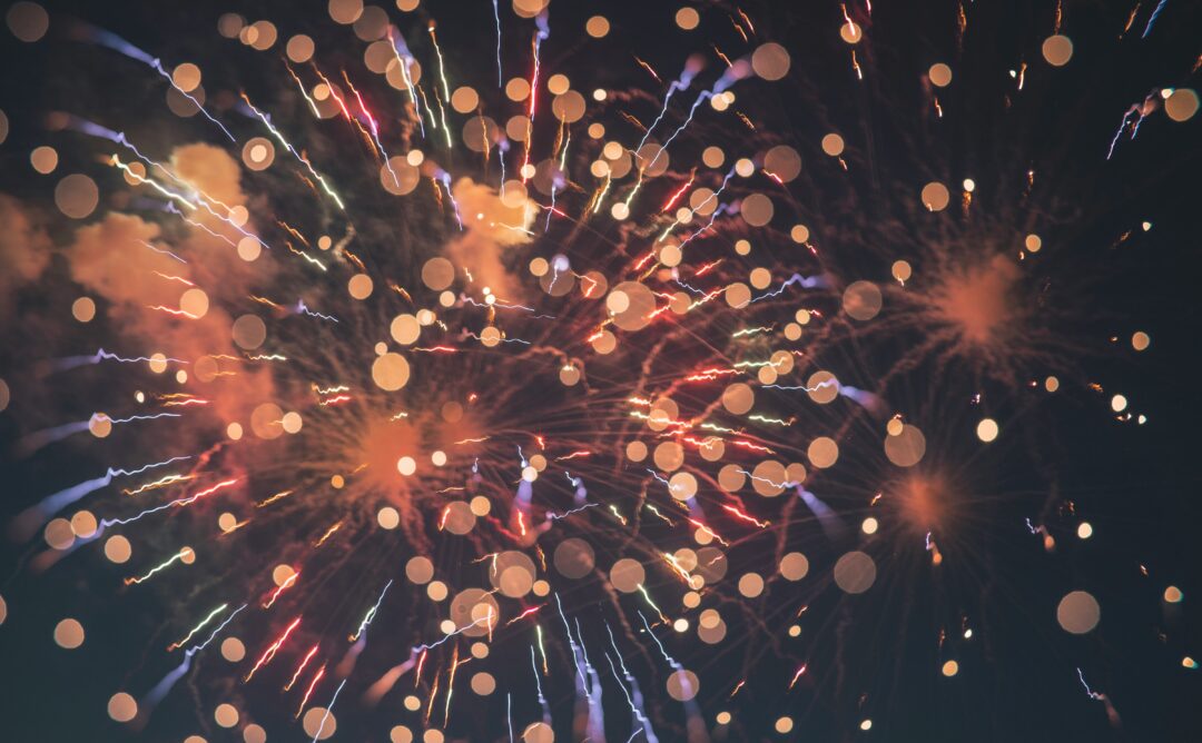 This is a picture of orange and white fireworks against a black background. They represent celebrating the small things in life.